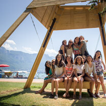 High School Semester Abroad! large group under canopy sitting on swing